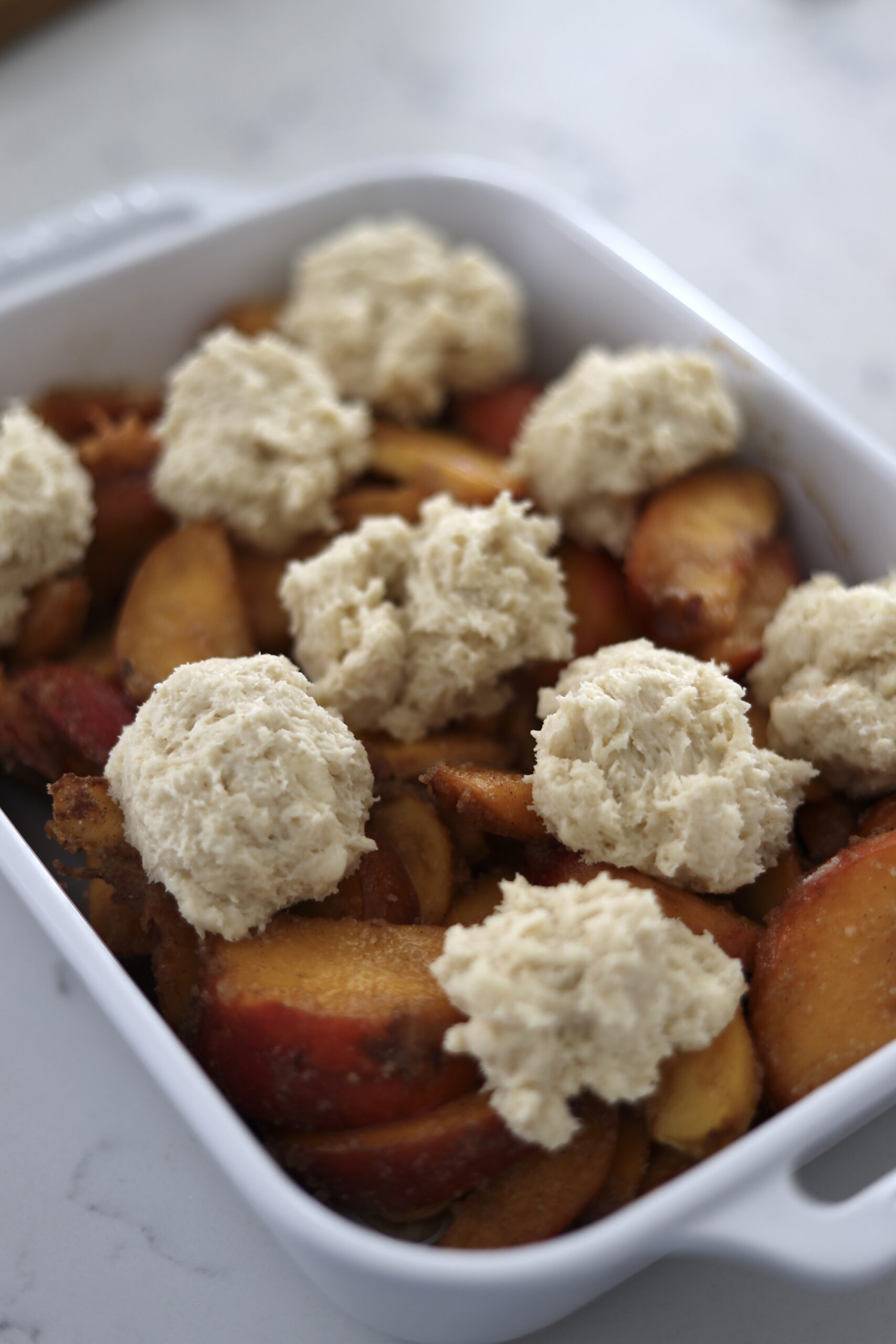 peaches being made into sourdough peach cobbler, a sourdough discard recipe