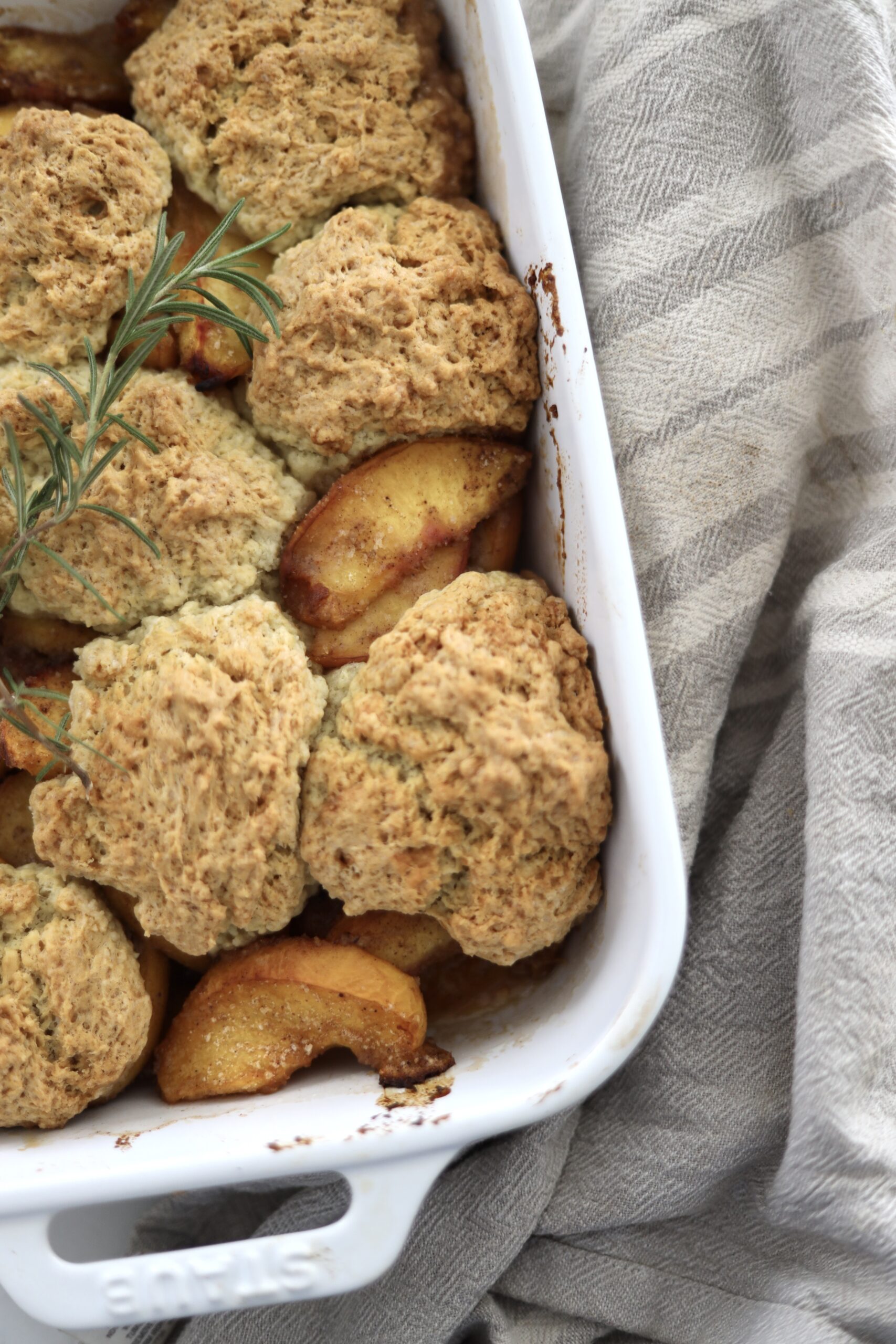 An up=close image of sourdough peach cobbler, a sourdough discard dessert