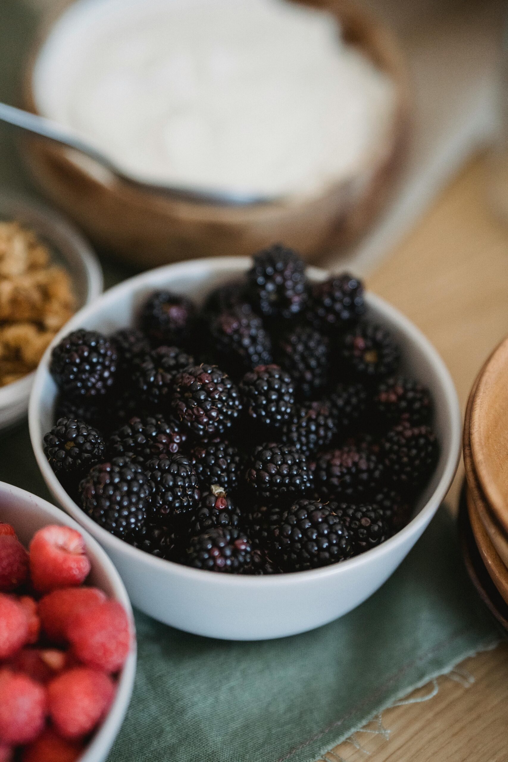 Bowl of fresh mixed berries prepared as a topping for homemade cream of wheat breakfast cereal.