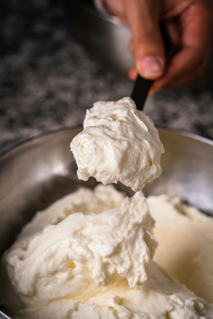 A scoop of raw milk sour cream, a homemade sour cream recipe