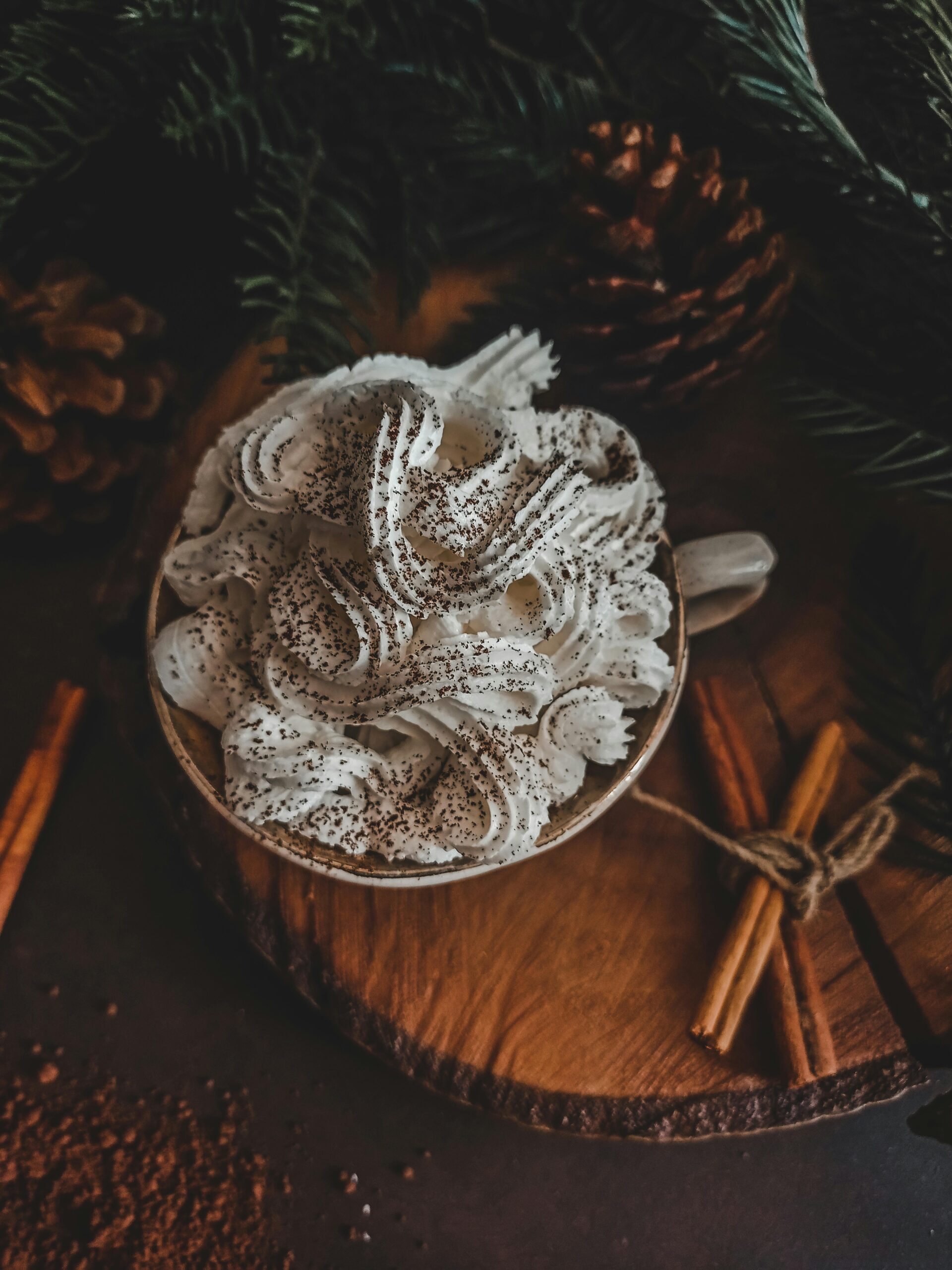 An up close view of raw milk eggnog topped with holiday spices, a traditional holiday treat