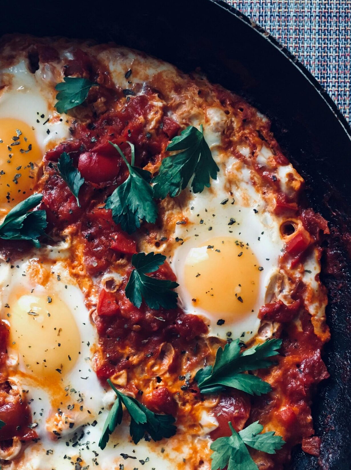 An up-close view of rustic shakshuka with cilantro, an easy, one pan breakfast