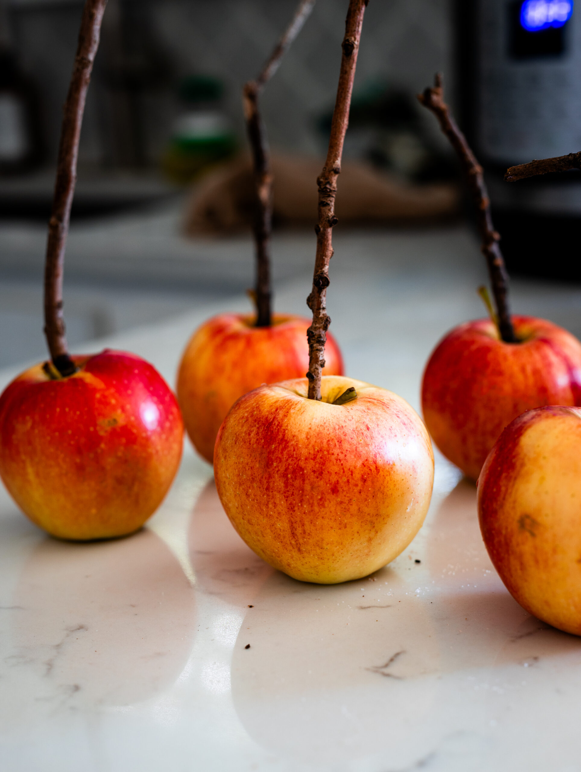 Preparing gala apples to make caramel apples