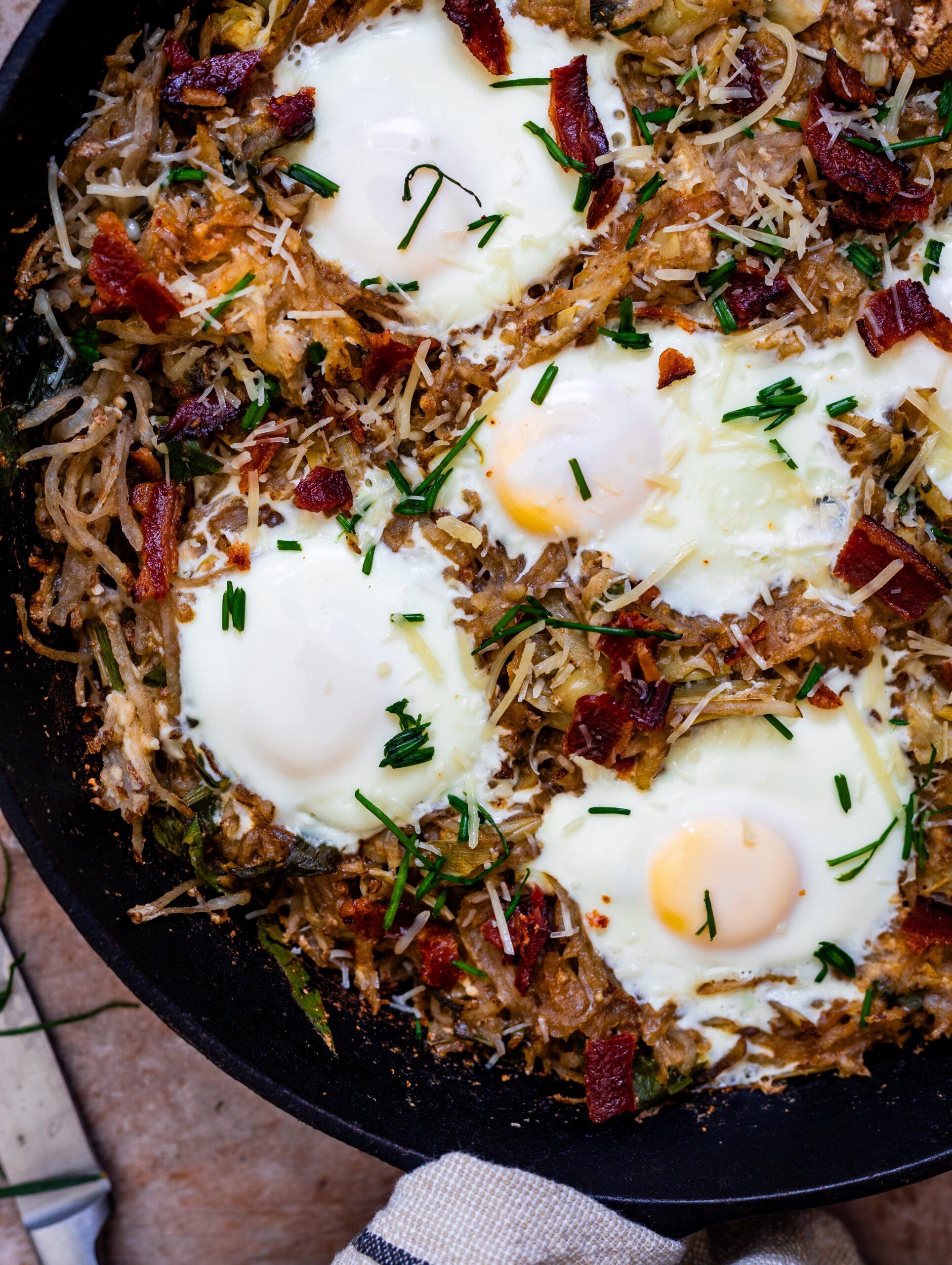 Egg, bacon, and potato hash with spinach and artichoke