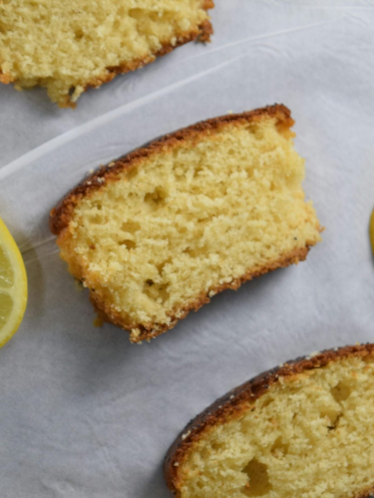 An up close image of slices of sourdough discard lemon loaf, a moist sourdough lemon cake