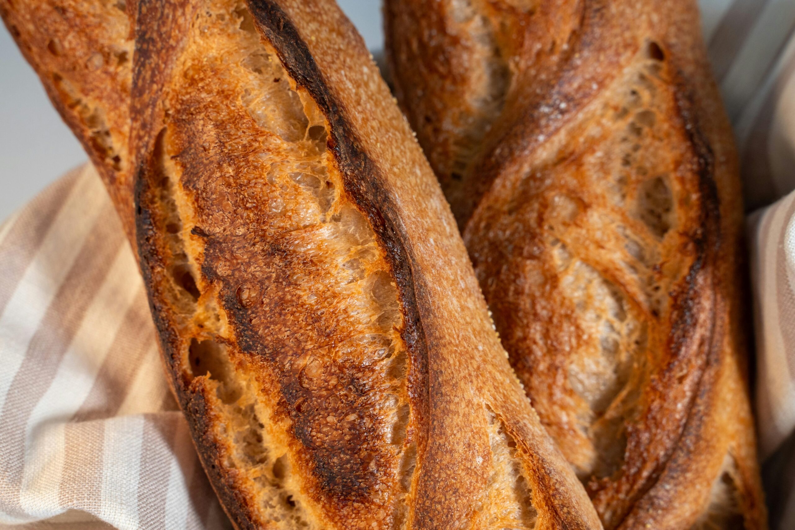 An up close view of a crispy crust sourdough baguette recipe and a homemade sourdough French bread recipe